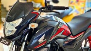 A close-up of a Honda SP 125 motorcycle. This image highlights the risks associated with the bike lacking essential safety features from TVS and Hero, emphasizing the importance of such features for rider safety.
