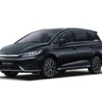 BYD eMax 7 electric SUV parked on a city street, showcasing its sleek design, futuristic LED headlights, and spacious 7-seater interior—highlighting its eco-friendly performance and cutting-edge tech.